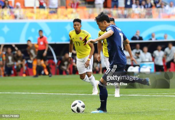 Shinji Kagawa of Japan scores his team's first goal from the penalty spot during the 2018 FIFA World Cup Russia group H match between Colombia and...