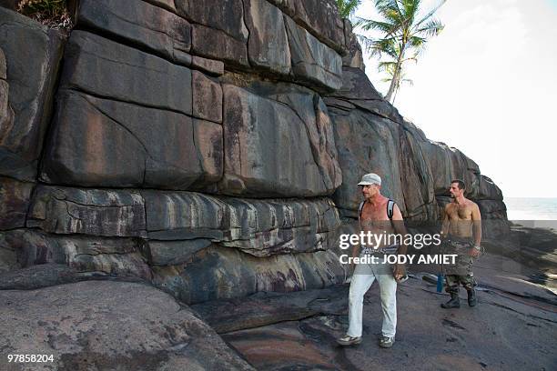Scientist of the Terre-Ocean mission, French geologist Eric Gilli walks, on February 13 on the Devil's Island in the Caribbean Sea off French Guiana,...