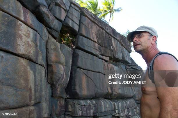 Scientist of the Terre-Ocean mission, French geologist Eric Gilli poses in front of a rock, on February 13 on the Devil's Island in the Caribbean Sea...