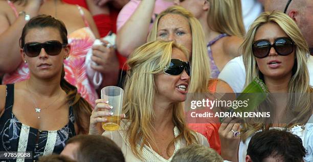 Colleen McLoughlin , the girlfriend of English forward Wayne Rooney, and Alex Curran , fiancee of English midfielder Steven Gerrard, sit with friends...