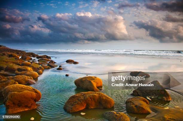 rocks on beach under cloudy sky, coxs bazar, chittagong division, bangladesh - coxs bazar stock pictures, royalty-free photos & images