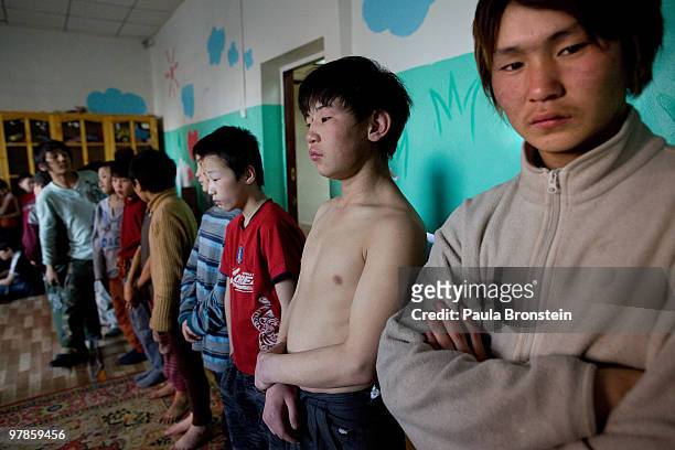 Mongolian street children stand at attention before excercise class at a child detention center March 11, 2010 in Ulaan Baatar, Mongolia. The police...