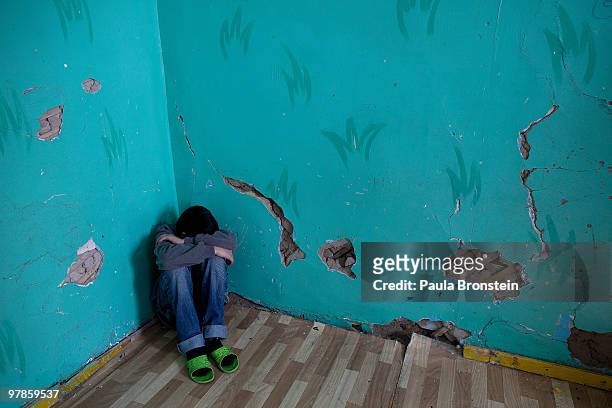 Mongolian street kid stays in a corner upset about being at a child detention center March 11, 2010 in Ulaan Baatar, Mongolia. The police picked up a...