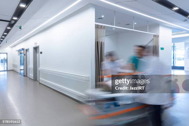 doctor wheeling patient - wheeling imagens e fotografias de stock