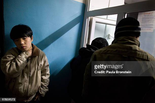 Mongolian street children wait in line to get registered at a child detention center March 11, 2010 in Ulaan Baatar, Mongolia. The police picked up a...