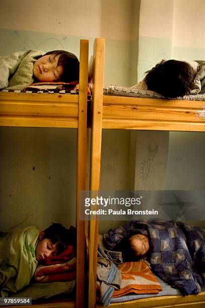 Mongolian street children sleep at a child detention center March 11, 2010 in Ulaan Baatar, Mongolia. The police picked up a dozen boys to get them...