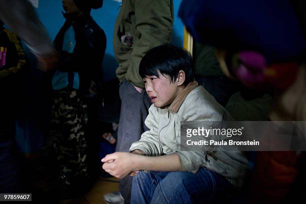 Mongolian street children wait in line to get registered at a child detention center March 11, 2010 in Ulaan Baatar, Mongolia. The police picked up a...