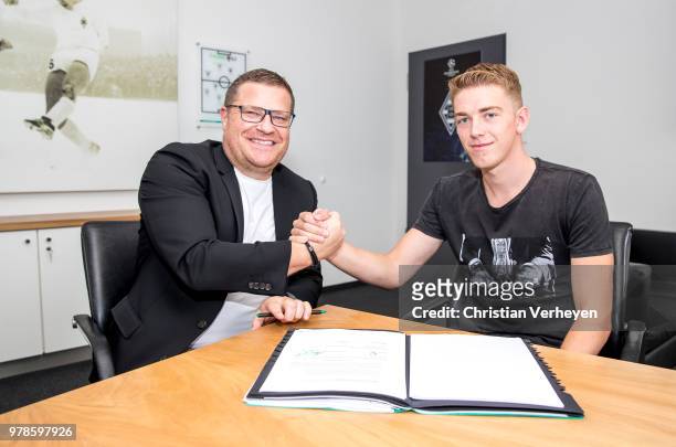 Director of Sport Max Eberl of Borussia Moenchengladbach and Andreas Poulsen pose after he signs a new contract for Borussia Moenchengladbach at...