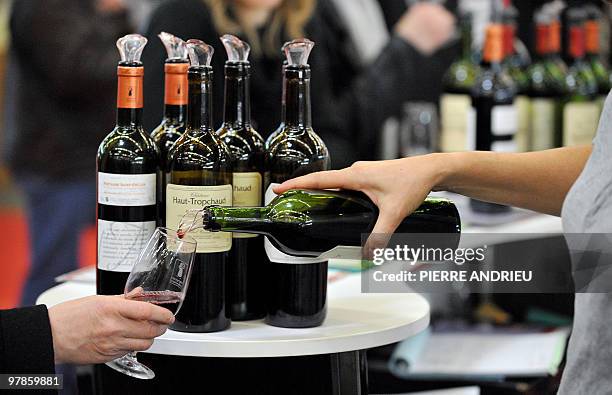 Les vignerons jouent la carte de la proximité pour sortir la tête de l'eau". A woman serves a glass of wine during the 11th edition of the...