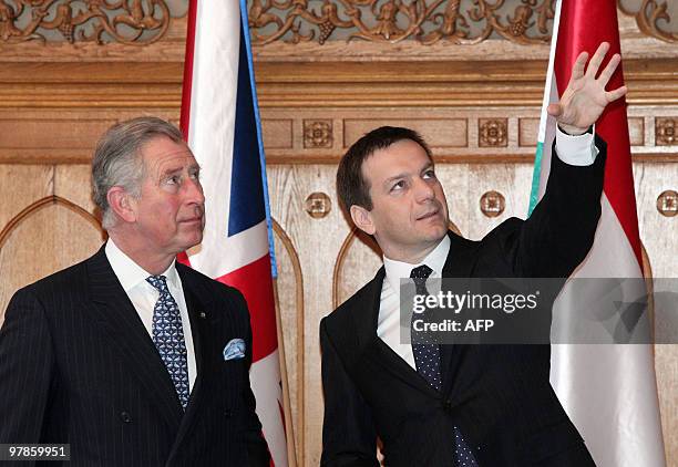 Britain's Prince Charles is guided by Hungarian Prime Minister Gordon Bajnai in Nandorfehervari Hall of the parliament building in Budapest on March...