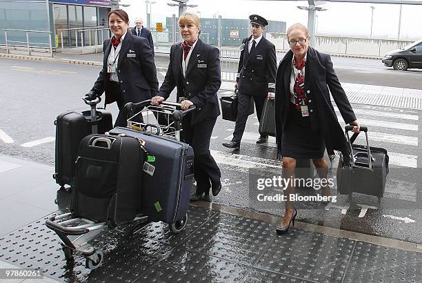 British Airways staff arrive at Terminal 5 at Heathrow airport in London, U.K., on Friday, March 19, 2010. British Airways Plc Chief Executive...