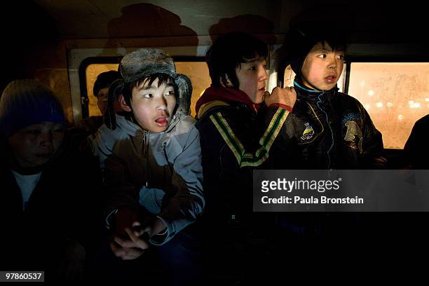 Mongolian boys crowd into a police van enroute to the child detention center March 11, 2010 in Ulaan Baatar, Mongolia. The police picked up a dozen...