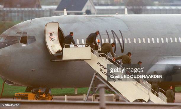 Personnel go down the gangway after the UN plane carrying two Libyans charged with 1988 Lockerbie airliner bombing arrived at the Navy airport...