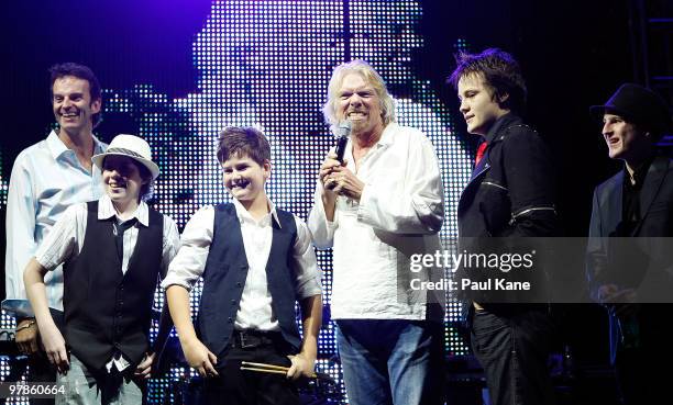 Sir Richard Branson talks with members of the youth band Radioactive during the "Branson By The Pool" function, as part of a series of fundraising...