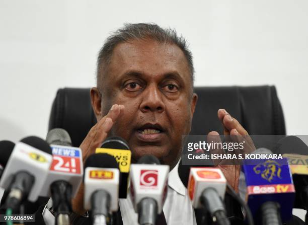 Sri Lanka's Finance Minister Mangala Samaraweera addresses a press conference to announce a 15% value added tax removal on doctors' consultation fees...