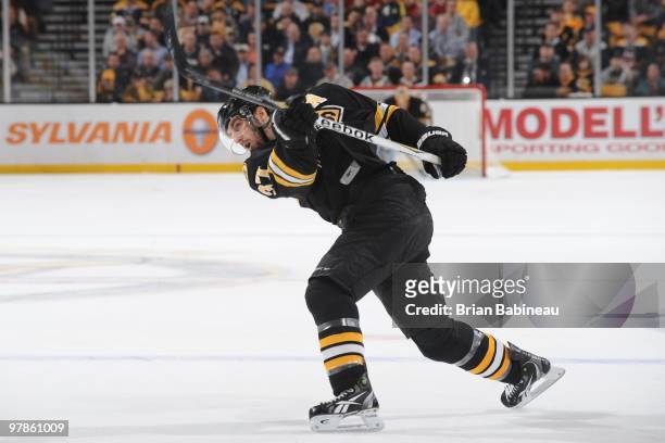 Patrice Bergeron of the Boston Bruins shoots the puck against the Pittsburgh Penguins at the TD Garden on March 18, 2010 in Boston, Massachusetts.