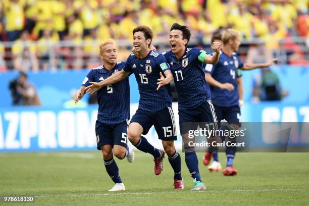 Yuya Osako of Japan celebrates scoring the 2nd Japan goal to make it 2-1 with Yuto Nagatomo and Makoto Hasebe of Japan during the 2018 FIFA World Cup...