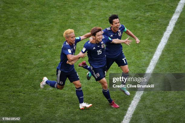 Yuya Osako of Japan celebrates scoring the 2nd Japan goal to make it 2-1 with Yuto Nagatomo and Makoto Hasebe of Japan during the 2018 FIFA World Cup...