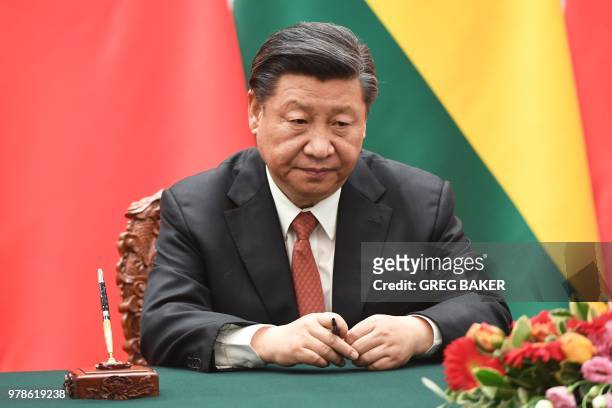 Chinese President Xi Jinping waits for his documents during a signing ceremony with Bolivia's President Evo Morales at the Great Hall of the People...