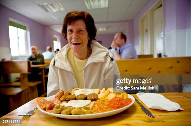Pat, a retired waitress sitting at a table with a huge full English breakfast at Smokey Joes transport cafe on 05th June 2008 in Blackwater in the...