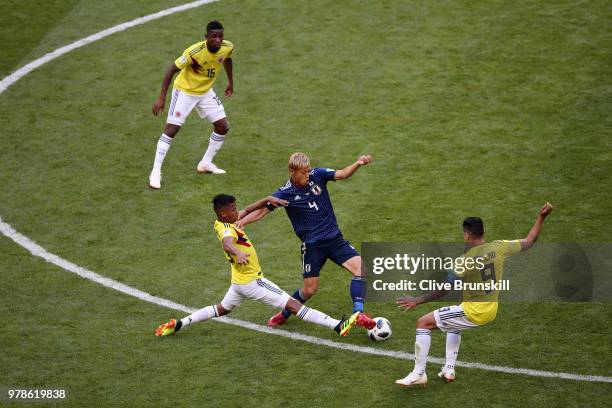 Keisuke Honda of Japan is tackled by Radamel Falcao and Wilmar Barrios of Colombia during the 2018 FIFA World Cup Russia group H match between...