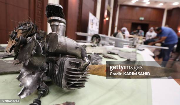 Picture taken on June 19, 2018 in Abu Dhabi shows Iranian-made Ababil drones and its parts which the Emirati armed forces say were used by Huthi...