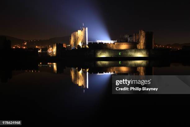 castle reflecting in water at night, caerphilly, south wales, uk - caerphilly castle stock-fotos und bilder