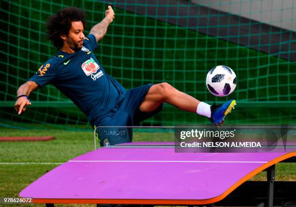 Brazil's defender Marcelo plays a shot over a table tennis table during a training session of Brazil national football team at Yug Sport Stadium, in...