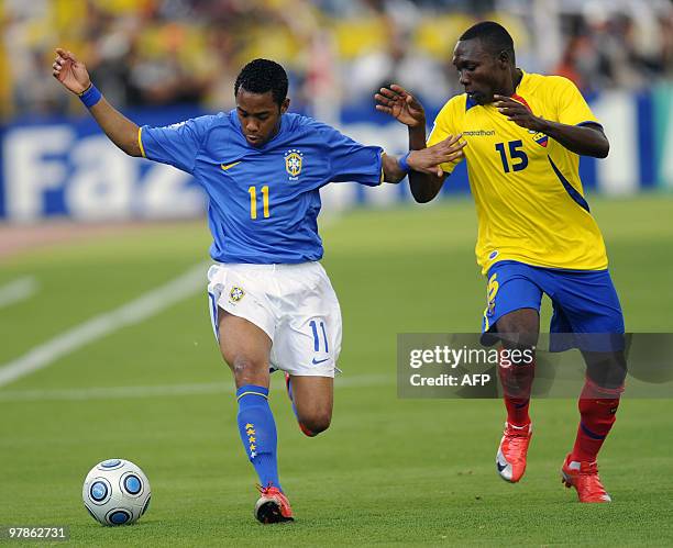 Brazilian Robinho vies for the ball with Ecuadorean Walter Ayovi during their FIFA World Cup South Africa-2010 qualifier football match at the...