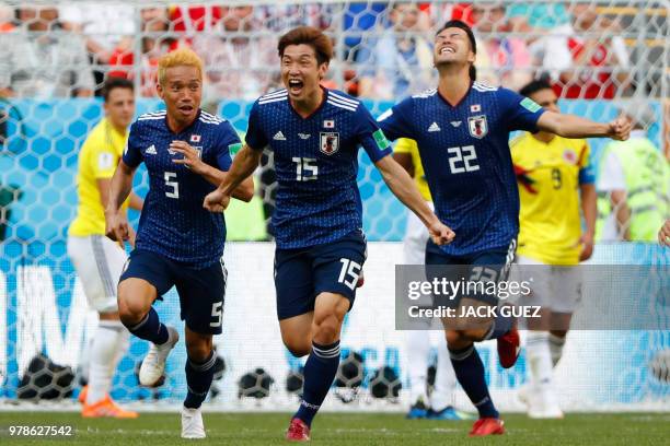 Japan's forward Yuya Osako celebrates with teammates after scoring a goal during the Russia 2018 World Cup Group H football match between Colombia...