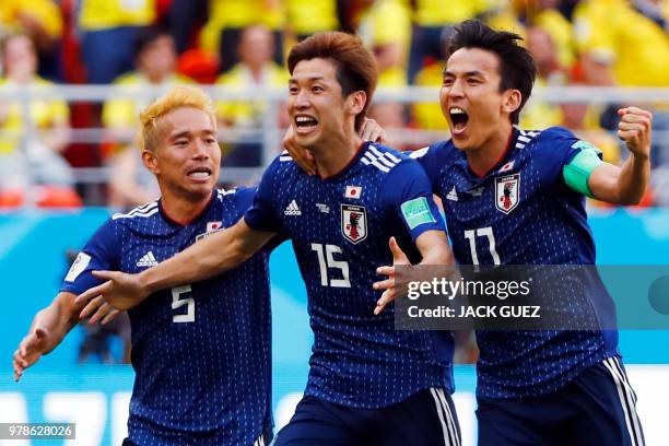 Japan's forward Yuya Osako celebrates with Japan's defender Yuto Nagatomo and Japan's midfielder Makoto Hasebe after scoring a goal during the Russia...