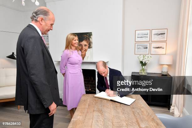 Nick Wentworth-Stanley and Clare Milford Haven look-on as The Duke of Cambridge signs the guest book during a visit to James' Place in Liverpool on...