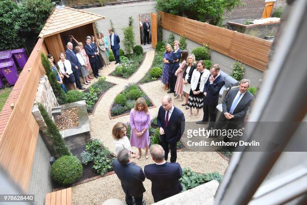 Clare Milford Haven introduces the The Duke of Cambridge to guests in the garden during a visit to James' Place in Liverpool on June 19, 2018 in...