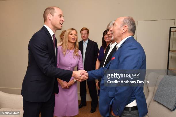 The Duke of Cambridge speaks to Peter Moore CEO Liverpool FC during a visit to James' Place in Liverpool on June 19, 2018 in Liverpool, England....