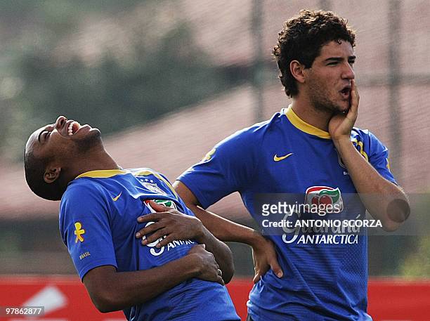 Brazilian footballer Robinho laughs next to teammate Alexandre Pato during a training session of the national team on June 11 in Teresopolis, Brazil....
