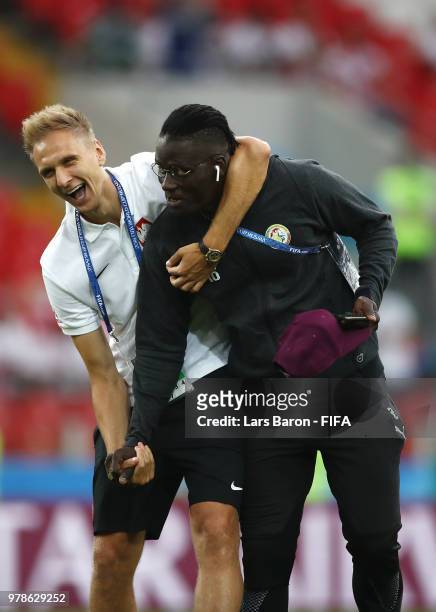 Lukasz Teodorczyk of Poland jokes with Kara Mbodji of Senegal during pitch inspection prior to the 2018 FIFA World Cup Russia group H match between...