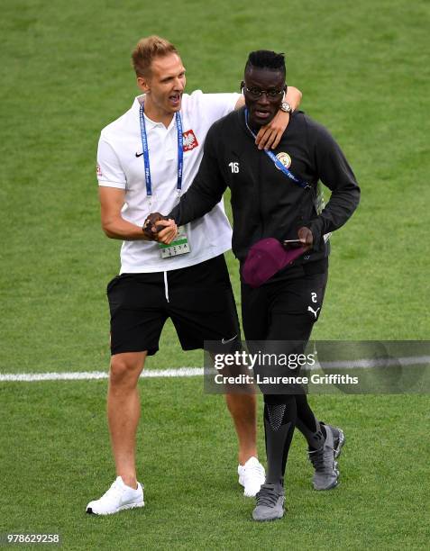 Lukasz Teodorczyk of Poland jokes with Kara Mbodji of Senegal during pitch inspection prior to the 2018 FIFA World Cup Russia group H match between...