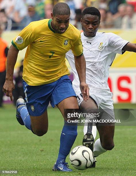 Brazilian forward Adriano vies with Ghanaian midfielder Eric Addo during the round of 16 World Cup football match between Brazil and Ghana at...