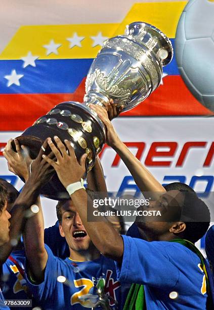 Brazil's footballe Robinho throws a kiss to the Copa America trophy during the awarding ceremony after winning against Argentina the Copa America...