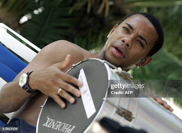 Brazilian player Robinho drums a tam-tam, a musical instrument used in the samba, at the hotel's garden, 11 July 2007, in Maracaibo, Venezuela....