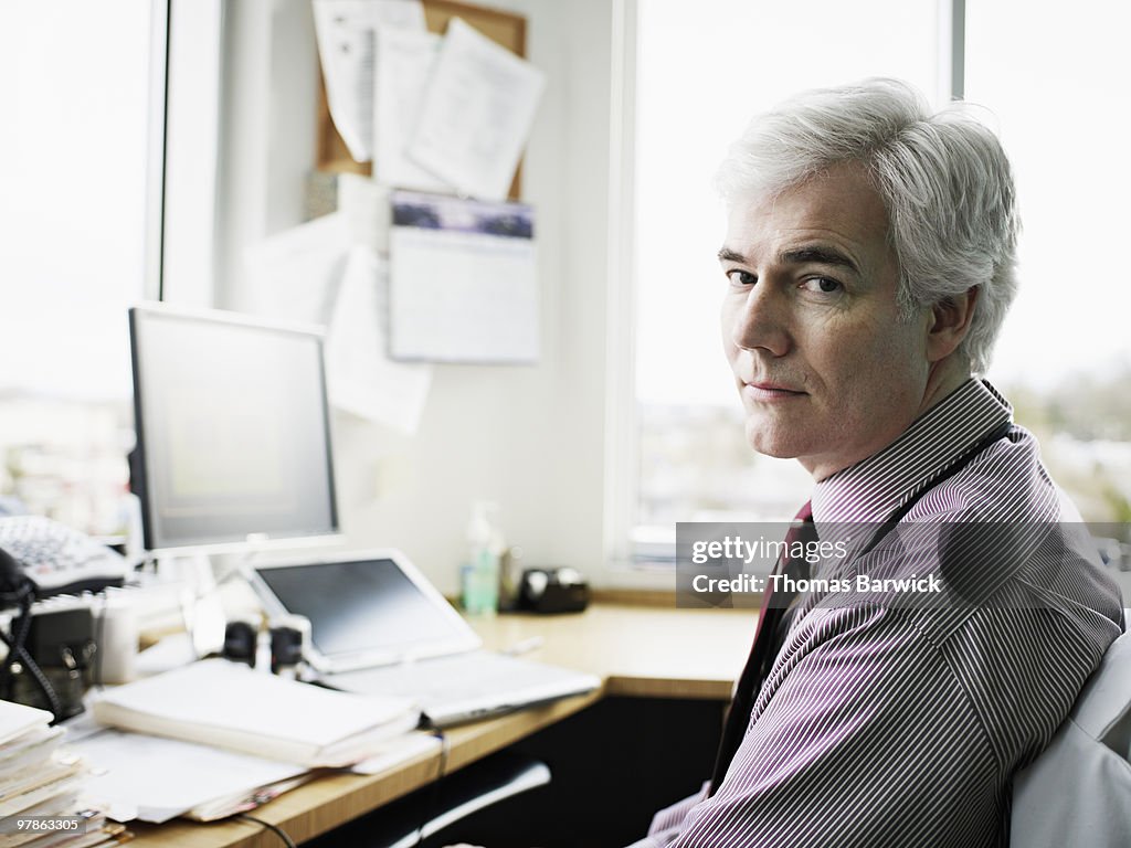 Portrait of male doctor at desk