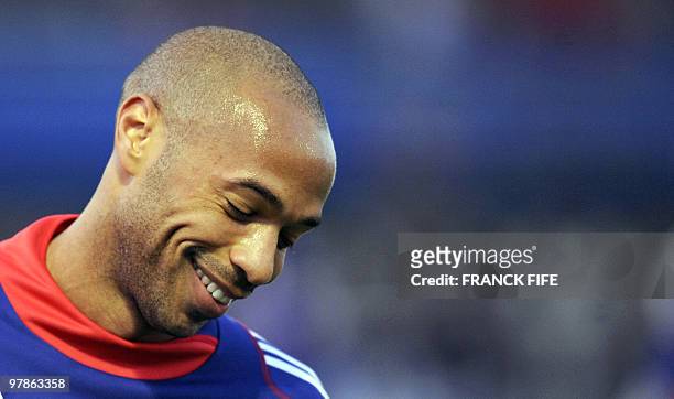 French national football team's captain Thierry Henry smiles while attending a training session, on November 11, 2009 in Clairefontaine, southern...