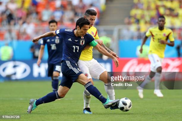 Makoto Hasebe of Japan is challenged by James Rodriguez of Colombia during the 2018 FIFA World Cup Russia group H match between Colombia and Japan at...