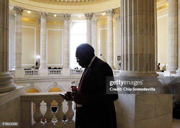 House Majority Whip James Clyburn looks at his Blackberry while taking a short break from a Democratic caucus meeting in the Canon House Office...