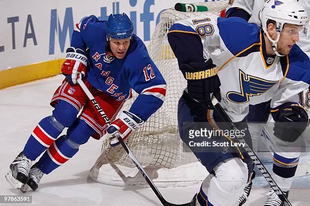 Olli Jokinen of the New York Rangers skates against Jay McClement of the St. Louis Blues in the first period on March 18, 2010 at Madison Square...
