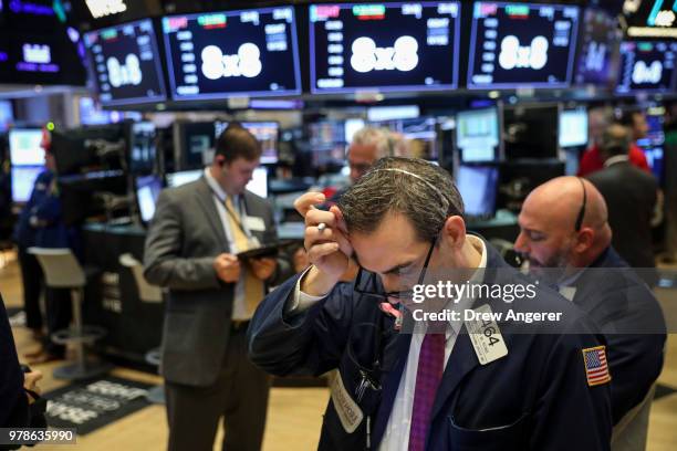 Traders and financial professionals work ahead of the opening bell on the floor of the New York Stock Exchange , June 19, 2018 in New York City. U.S....