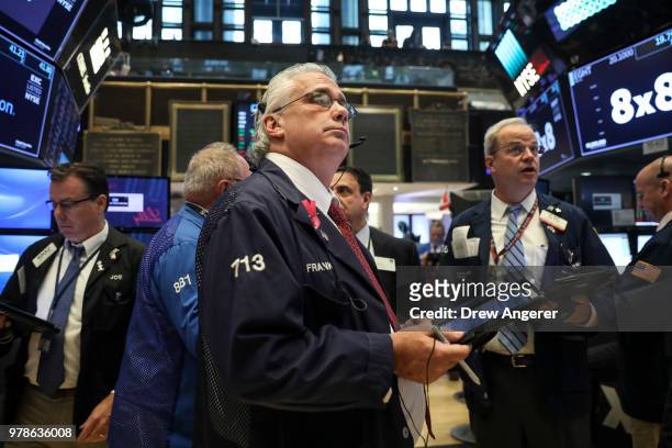 Traders and financial professionals work ahead of the opening bell on the floor of the New York Stock Exchange , June 19, 2018 in New York City. U.S....