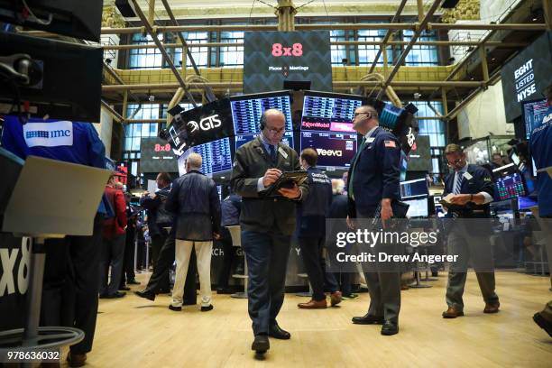 Traders and financial professionals work ahead of the opening bell on the floor of the New York Stock Exchange , June 19, 2018 in New York City. U.S....