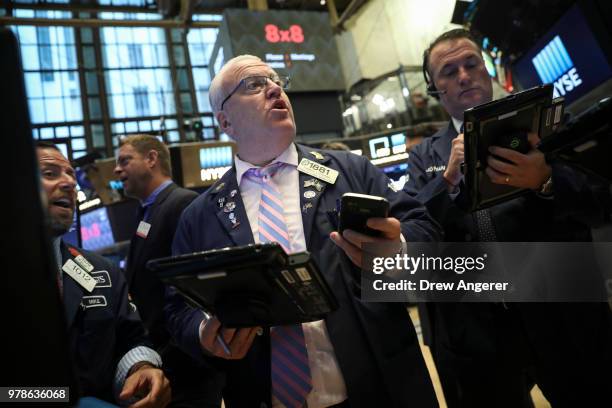 Traders and financial professionals work ahead of the opening bell on the floor of the New York Stock Exchange , June 19, 2018 in New York City. U.S....