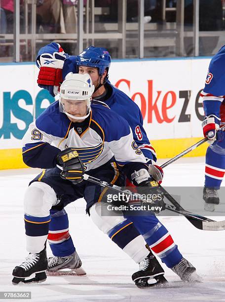 Brandon Prust of the New York Rangers skates against Paul Kariya of the St. Louis Blues in the first period on March 18, 2010 at Madison Square...